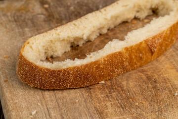 A cut loaf of round-shaped wheat bread