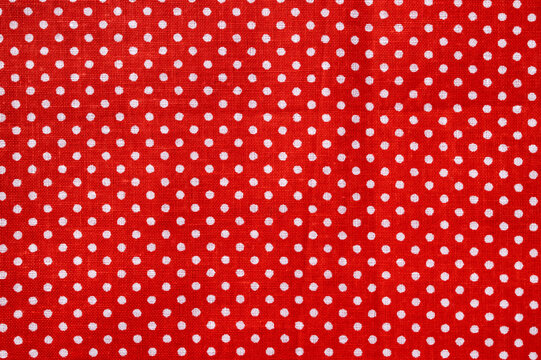Red and white polka dot cotton texture. Fabric textile background