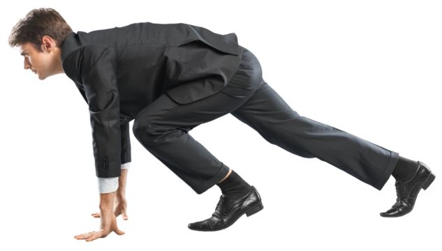 Young businessman in start pose for running isolated on white