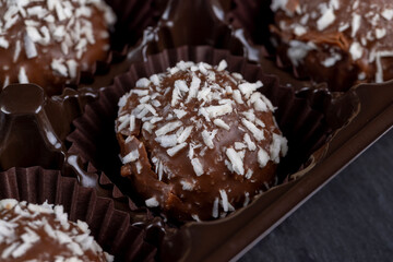 Chocolate candies in the form of balls with milk coconut