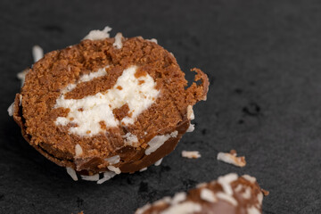 Chocolate candies in the form of balls with milk coconut