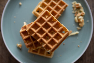 Fresh baked waffle in a pattern on wooden background, top view