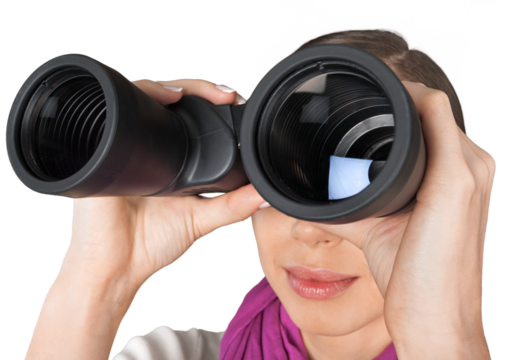 Girl looking into binoculars isolated on white