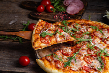 Appetizing pizza with ham on a wooden background
