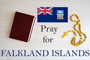 Pray for Falkland Islands. Rosary and Holy Bible background.