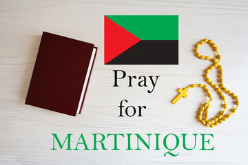 Pray for Martinique. Rosary and Holy Bible background.