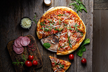 Appetizing pizza with ham on a wooden background