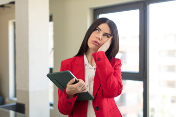 Fototapeta premium pretty young woman feeling bored, frustrated and sleepy after a tiresome. touch screen pad concept
