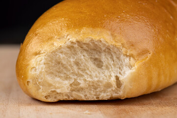 Wheat baguette on a wooden cutting board