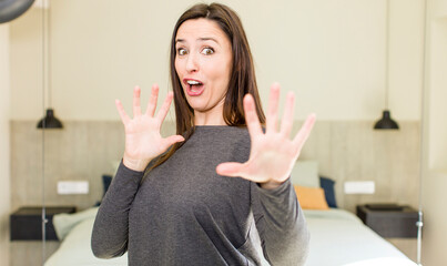 young adult pretty woman feeling terrified, backing off and screaming in horror and panic, reacting...