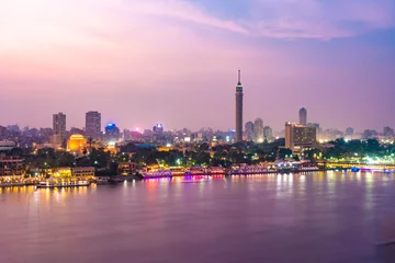 Foto op Canvas View of Nile river with El Gezira, zamalek, cairo tower and towers illuminated at night © TambolyPhotodesign