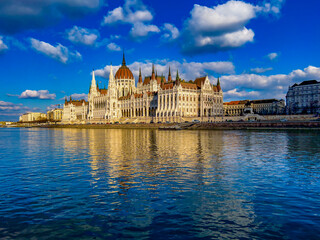 View of Parliament building of Budapest from the Danube river. neo-gothic style architecture.