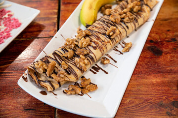 Crepes with bananas and covered with chocolate in a food market in Barcelona