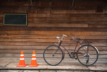 Vintage bicycle on old rustic dirty wall house, many stain on wood wall. Classic bike old bicycle...