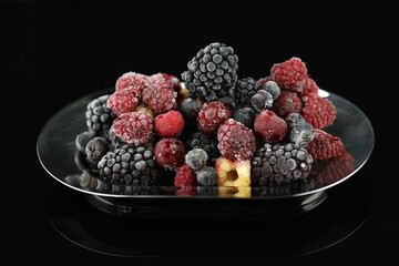 frozen berries with ice on the black background