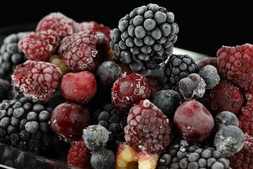 frozen berries with ice on the black background