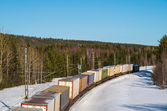 A Freight Train From Behind In Winter Landscpe.