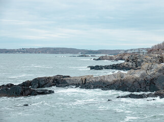 A cloudy and stormy winter early spring day on the coast of Maine in New England on the Atlantic Ocean.