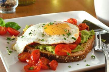 Avocado toast with sunny side up egg and coffee for breakfast, brunch or meal