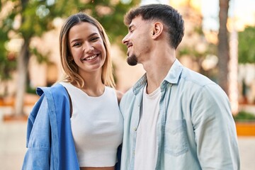 Obraz premium Young man and woman couple smiling confident standing together at street