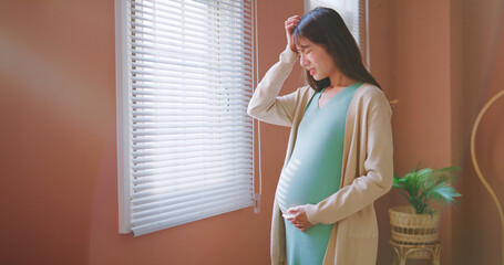 asian woman pregnant headache worry