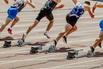 male sprinter runners starting running 100 - meter race in summer athletics championships