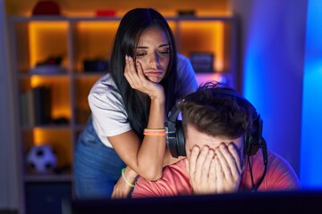 Man and woman streamers stressed playing video game at gaming room