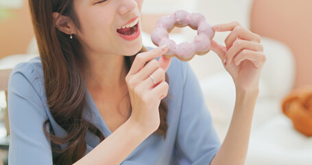 asian woman eating donuts happily
