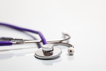 Close-up of stethoscope over reflective white surface