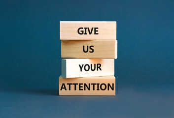 Give us your attention symbol. Concept words Give us your attention on wooden block. Beautiful grey table grey background. Motivational business give us your attention concept. Copy space.