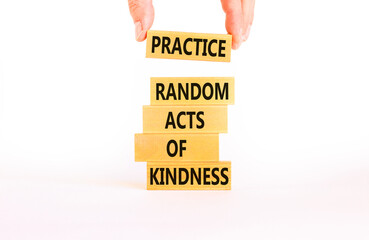 Practice random kind of kindness symbol. Concept words Practice random kind of kindness on wooden block. Beautiful white background. Businessman hand. Business practice kindness concept. Copy space.