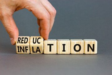 Inflation or reduction symbol. Concept word Inflation Reduction on wooden cubes. Businessman hand. Beautiful grey table grey background. Business inflation or reduction concept. Copy space.