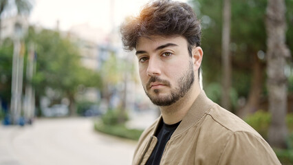 Fototapeta premium Young hispanic man standing with serious expression at street