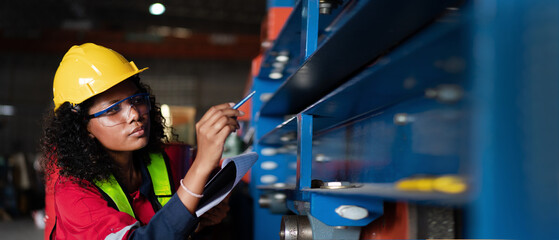 Industrial Engineers or Foreman inspecting and check up machine at factory machines.Technician working in metal sheet at industry..