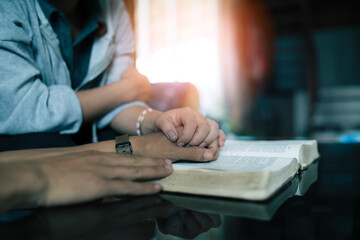 Wife and husband reading the Bible in their home, faith and trust. Family, worship and praise with married couple man and woman united in prayer, holy or gratitude to Jesus Christ.