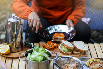 Cooking healthy vegetarian sandwiches. Female hands preparing delicious sandwiches, closeup. Eating right concept