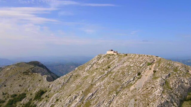This stock video showcases the breathtaking aerial footage of the Njegos Mausoleum located at the top of the Jezerski peak in Montenegro. The mausoleum is a stunning architectural masterpiece