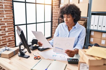 African american woman ecommerce business worker reading document at office