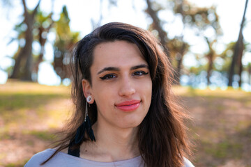 Young latin transgender woman wearing casual clothes happy face smiling looking at the camera. positive person. - obrazy, fototapety, plakaty