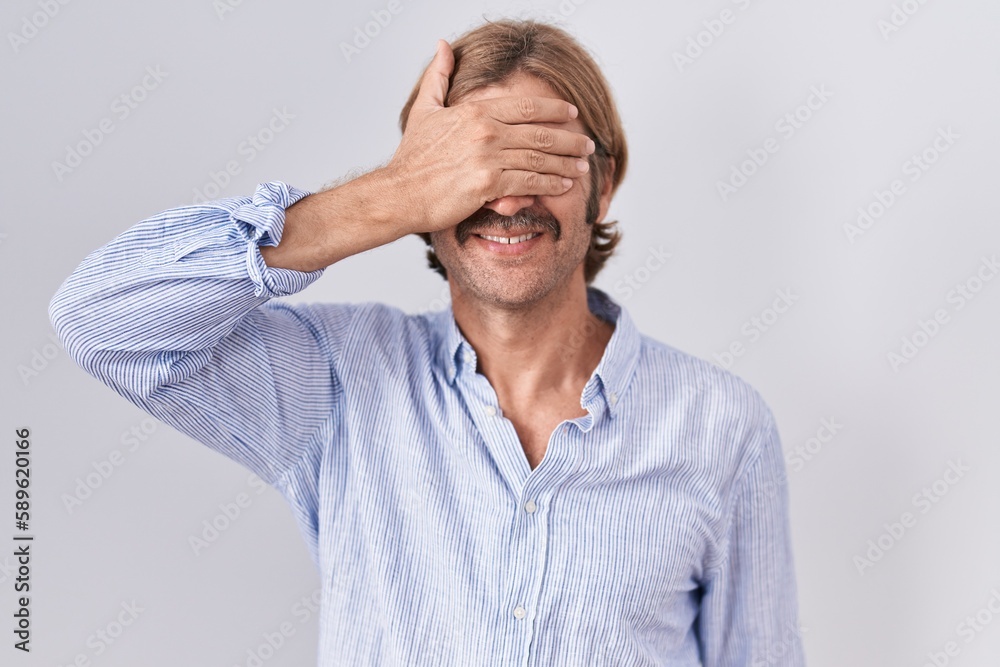 Canvas Prints caucasian man with mustache standing over white background smiling and laughing with hand on face co