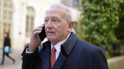 senior speaking on the phone at street