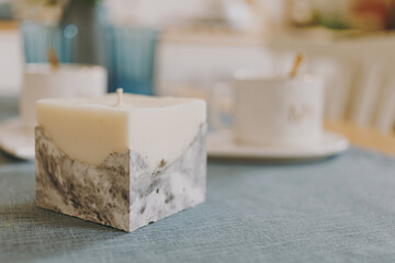 Wax candle with concrete base