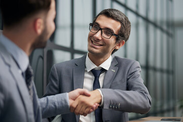 Fototapeta premium Two diverse business men analysts partners talking, working together