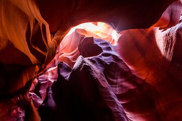 Antelope Canyon in the Navajo Reservation Page Northern Arizona. Famous slot canyon. Light showing off the glamorous detail of the ancient spiral rock arches. Multicolored texture, rock formation.