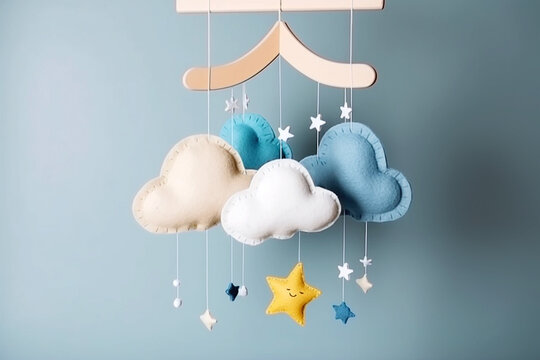 Baby crib mobile with stars, clouds and moon. Kids handmade toys above the newborn crib. First baby eco-friendly toys made from felt and wood on grey background. AI generated image