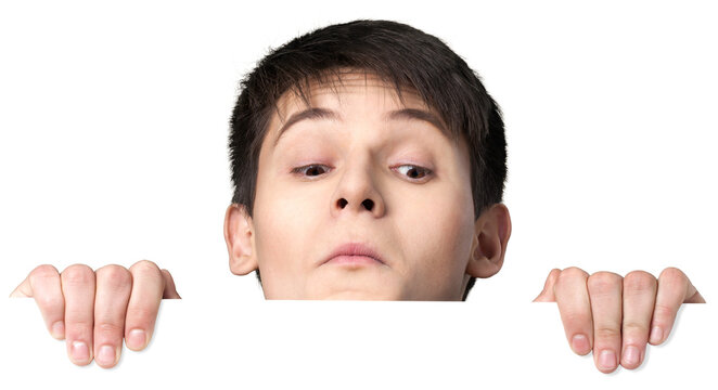 Young man peering over a blank sign