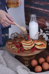 breakfast with milk, pancakes with fruit and honey