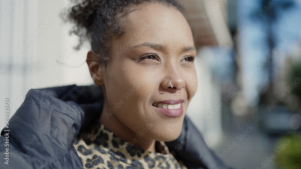 Sticker African american woman smiling confident looking to the side at street