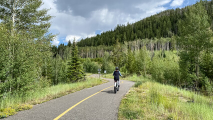 woman biking through the mountains