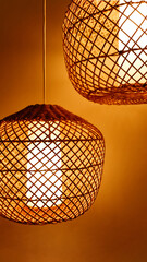 Wicker rattan lamps hanging from the ceiling. Lamp shade. Light and shadow.